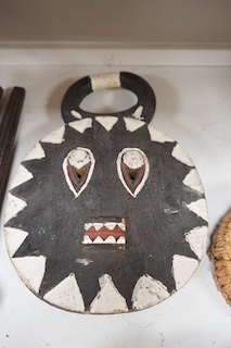 Three African tribal masks and a carved folding tray, largest 92cm. Condition - fair to good